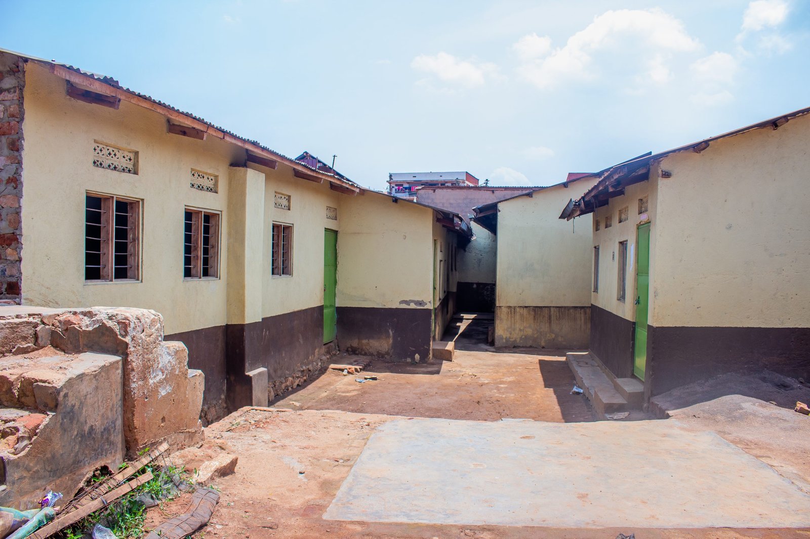The quiet courtyard between two whitewashed blocks of a Streams of Joy Services safe house
